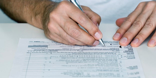Man Filling out Tax Form