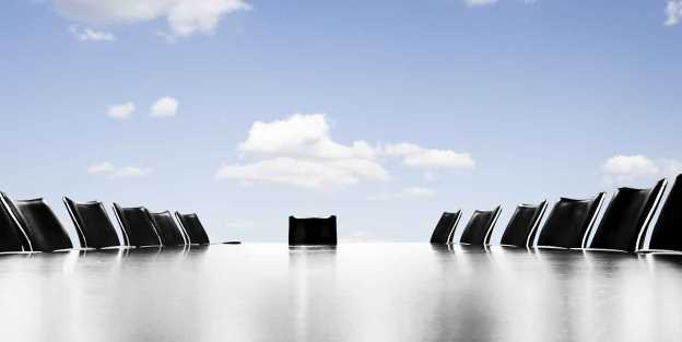 Office table with empty chairs with sky in background