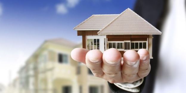 Man holding mini House in Hand