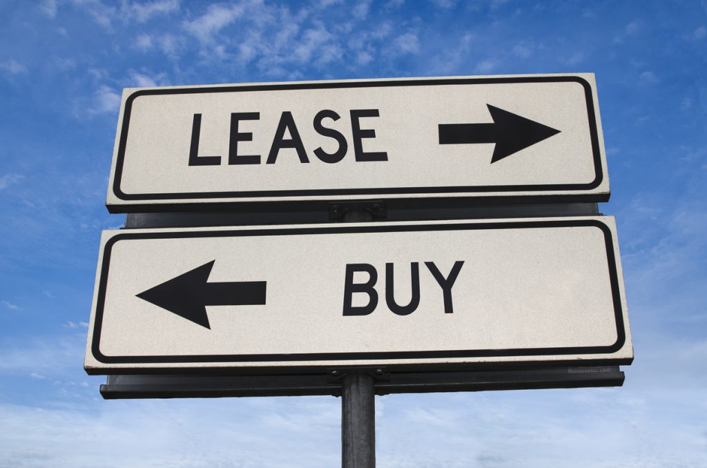 Road sign with 'lease' and 'buy' pointing in opposite directions