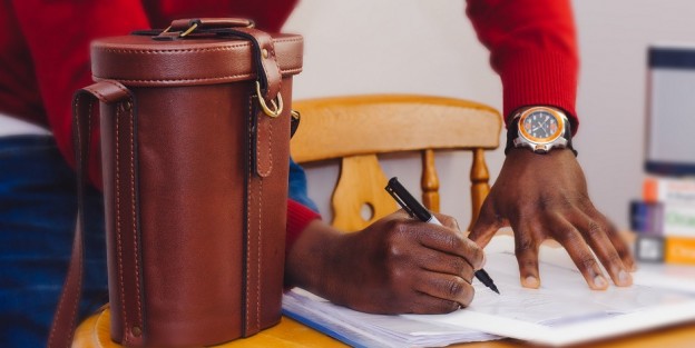 Man standing and signing document