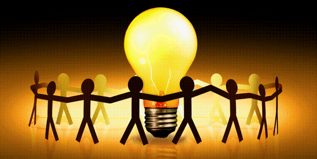 Paper cutouts of people holding hands around lightbulb