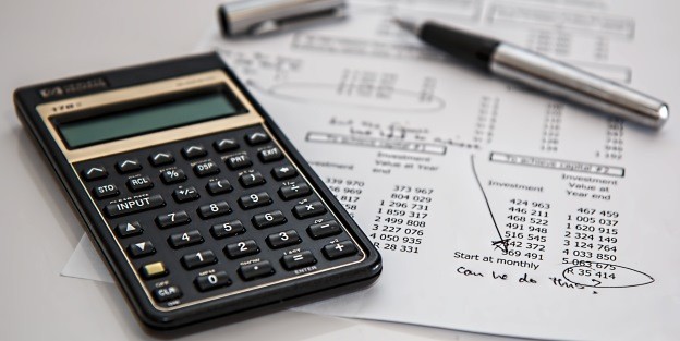 Calculator and pen on financial report