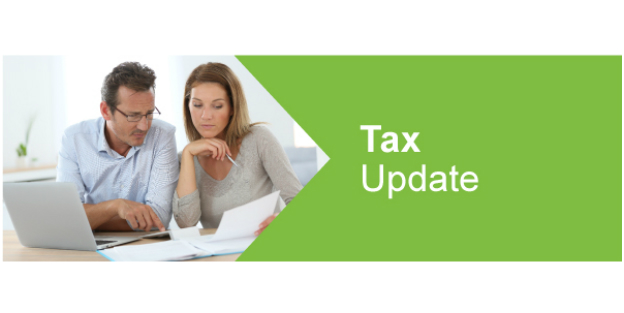 Couple reviewing finances with Tax update written on green background