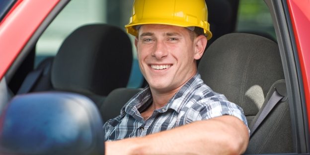 Happy contractor sitting in car