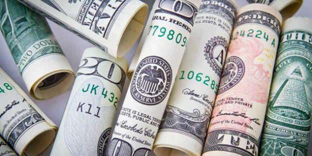 US Dollar bills rolled up