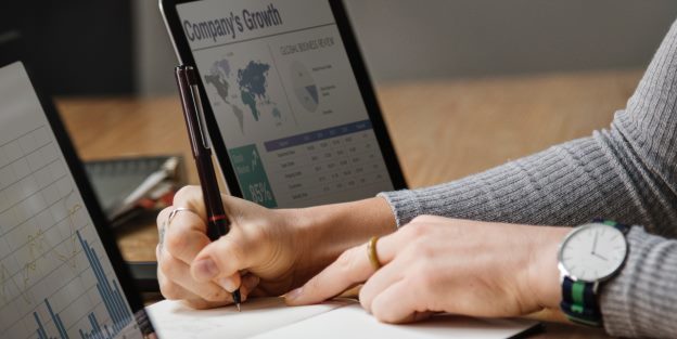 Business woman analyzing charts and graphs for company's growth