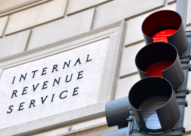 Red traffic light in front of Internal Revenue Service building