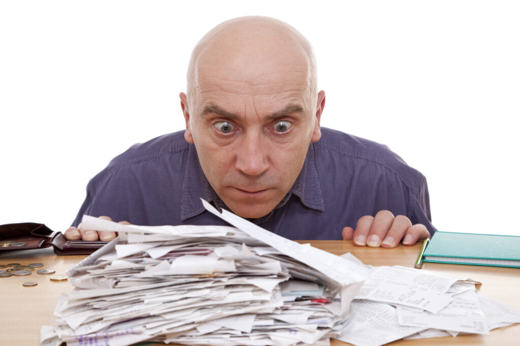 Man staring at pile of taxes trying to figure out how to make tax preparation more efficient