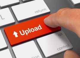 Finger hitting red upload button on key board