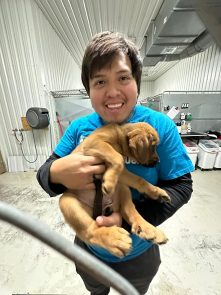 Renzo Yparraguirre and a puppy at the SPCA